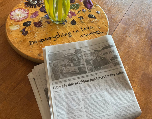 Fire Prevention Resources for Every Homeowner. A picture of a newspaper sitting on a table in front of a flower vase, showing FireFighter1 in the news talking about fire safety.