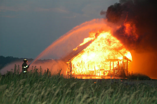 Pool Owners: Your Secret Fire Hydrant is Already in Your Backyard! A firefighter putting out a house on fire by extinguishing it with sprayed special water solution.