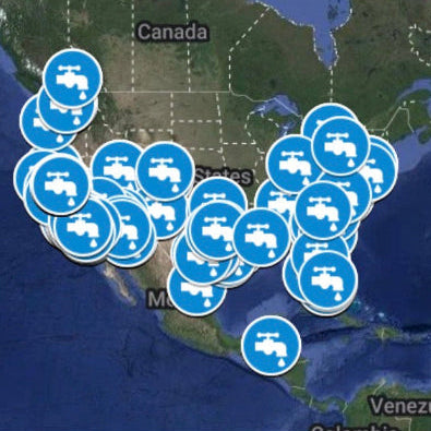 A map of North America and the surrounding ocean with multiple blue circular icons containing white truck symbols clustered over Mexico, Texas, Louisiana, Arkansas, and Oklahoma, plus one icon in the open ocean.